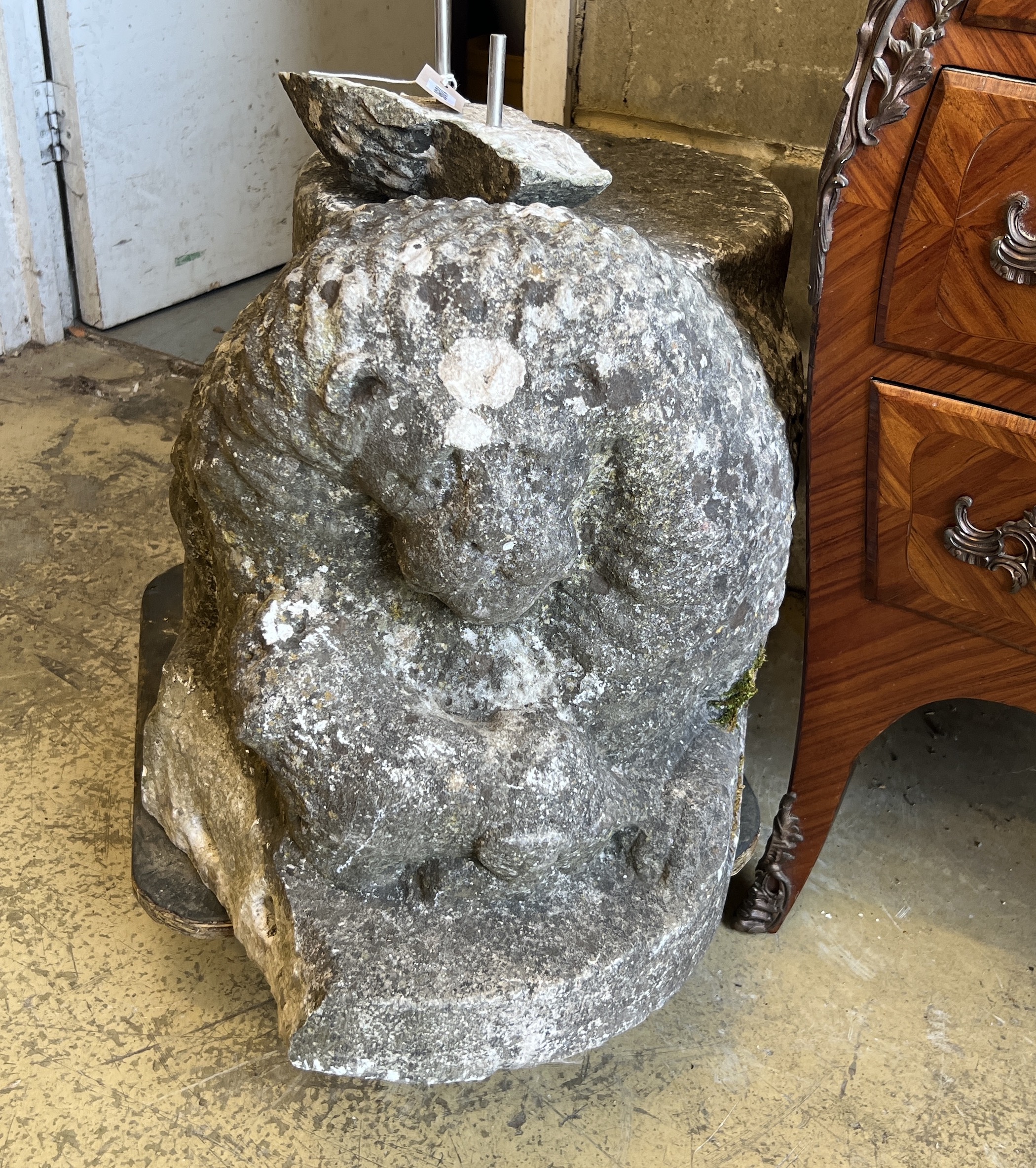 A carved stone lion, (probably antique and a column support) length 84cm, depth 40cm, height 45cm